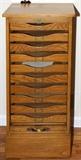 Lot#1561, AMERICAN OAK TAMBOUR-FRONT FILING CABINET, H 45", W 19", D 17"The sliding front opens to reveal nine drawers.