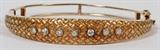 Lot#2072, 14KT YELLOW GOLD BANGLE BRACELET WITH DIAMONDS.21.6 grams total weight; 2.25" inner width; H 2"