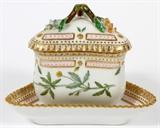 Lot#2077, ROYAL COPENHAGEN "FLORA DANICA", PORCELAIN TRIANGULAR COVERED CUSTARD CUP & SAUCER.Saucer, 4" x 4 3/8"; cup, H 3".  Family owned since the late 1970's to early 1980's.