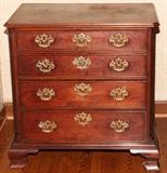 Lot#2169, GEORGE III MAHOGANY CHEST OF DRAWERS, C. 1770, H 32", W 31", D 17"Single-width mahogany top with beveled edge and canted corners, fitted with four graduated drawers with cockbeaded edges and pierced Chippendale post and bail brasses and matching escutcheon plates, on ogee bracket feet.  Oak secondary wood.  Measures H.32 1/2" x 31 1/2" x 17 1/2".