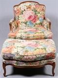 Lot#2364, BAKER FURNITURE CO WALNUT CHAIR AND OTTOMAN.Oversize chair, walnut frame, tapestry upholstery. Two seat cushions.