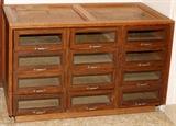 Lot#2370, OAK CABINET WITH GLASS-FRONT DRAWERS, H 29", W 48", D 22"Fitted with twelve glass-front drawers.