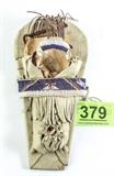 Lot#:	379
Description:	Miniature Ute Doll Cradleboard: White Deerskin
Deerskin, willow and beadwork cradleboard by Navajo, Mary Turtle. Styled like the Ute Mountain Ute tribe. The white Deerskin leather is expertly tassled, and woven to wrap the board. Beads in rainbow colors adorn the body "buckle" and "head strap", and a bent stick shade goes over the very top. In overall good condition, except one spot on the bottom right which has some damage.
Measures 12" long x 6 1/2" wide ( at the widest.)
Tagwords: western / southwestern, native american indian, dolls, intdes, interior design
