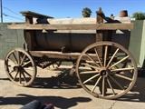 Lot#:	164
Description:	Antique Horse Drawn Water Wagon Farm Equipment
This is 1 of 70 wagons that will be sold between November 2014 and February 2015!
Take a trip back in time when the Old West, or the Wild West, was being explored and settled. The buggies, carriages, wagons and coaches featured in this auction are authentic relics of the frontier history. These items are from the Richard Bunger Estate in Payson, AZ and were purchased by Mr. Bunger from various places including the McElhaney Cattle Co Museum in Yuma, AZ. This lot features a horse drawn water wagon. It has an unpainted round cylindrical tank with galvanized steel with welded seams and a fill cap on top rear of tank. Mounted in a wood cradle and frame on steel reinforced primitive wood frame. A wood block braking system on underside and steel rimmed wood spoke wheels. It has a flat seat on front with plank foot rest for driver. Stenciled with an open A and enclosed v on one end, possible "Diamond A" brand mark. Dry rot 