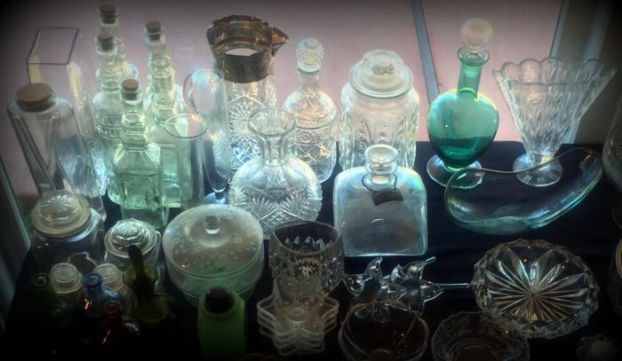 Neat collection of colored glass bottles and serving items !