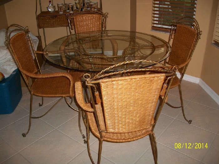 Metal and glass top table with 4/ metal and wicker chairs