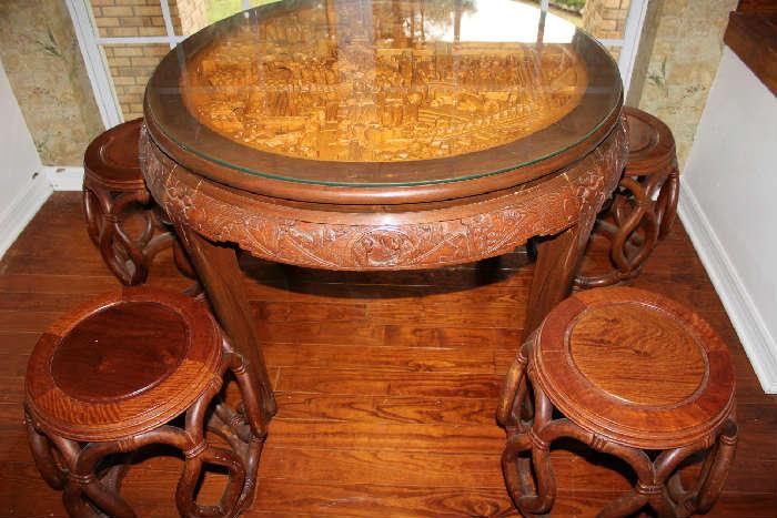 CARVED TABLE AND FOUR STOOLS