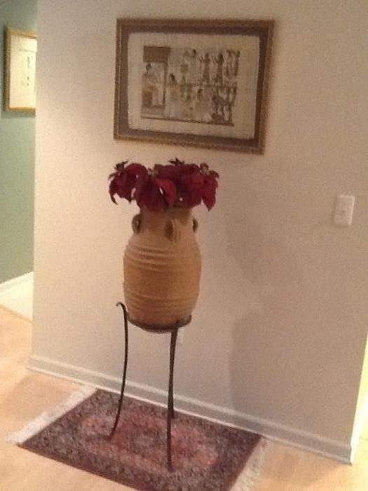 Framed artwork, small wool area rug, ceramic planter and stand