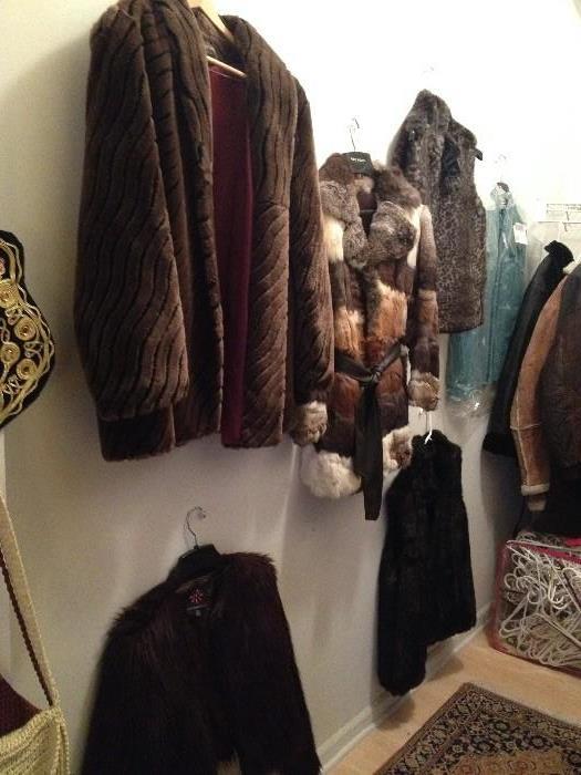 fur coats and faux coats and vest, several more leather coats with fur collars.