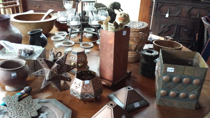 View of interesting copped and metal pieces, baskets and hand carved wood bowl