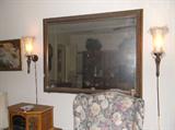 Large beveled mirror and Tuscan-style wall lamps