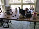 Small kitchen table and various household items.