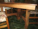 Oak dining table closed is 48" X 48" and extends for 3 leaves revealing a 5th leg.