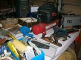 Three car garage is filled with tools and many other treasures