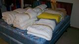 Queen bed with frame
mattress pads, blankets and pillows on bed