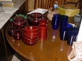 Some of the many sets of dinnerware, glassware, etc.