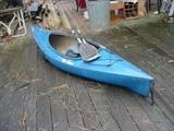 nice old kayak with skirt and paddles