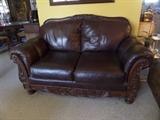 Leather love seat (5ft.) ornate wood trim