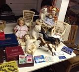 Dolls by Gotz & Ideal, stuffed animals, 2 Breyer horses, American Girl wicker doll furniture (round table & 2 chairs w/floral pads), playing cards