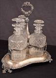 40  - Victorian tantalus set with 3 bottles, steppers, minor damage, 12 in. T, 10 in. W.