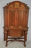74  - Mahogany heavily carved china cabinet with blind doors, gold trim, 71 in. T, 49 in. W, 21 in. D.