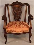 77  - Mahogany rococo arm parlor chair, pierced carved back with pink to gold upholstery, 32 in. T, 26 in. W, 20 in. D.