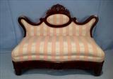 244  - Flame mahogany empire bustle bench with unusual shape and pink stripe upholstery, 37 in. T, 45 in. W, 18 in. D.