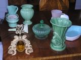 A large gold perfume bottle is in the foreground along with an example of some of the pottery, etc. we have for sale which includes a major collection of Fiesta, Hall, Bauer, Harlequin and Roseville.