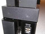 A pair of NHT SuperZero rears, a pair of PSB Stratus Minis, and a Polk Audio LSiC center are shown. We also have a Bob Carver Sunfire True Subwoofer Signature, a Tivoli Model One Radio, a JVC CD player, and a Sony VCR player. We additionally have a Kenwood SW-300 subwoofer and a new Synergy speaker to replace the original.