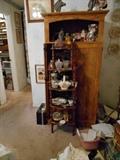 Curio stand and cabinet behind it
