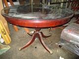 Mahogany Duncan Phyfe style pedestal table with a glass top.