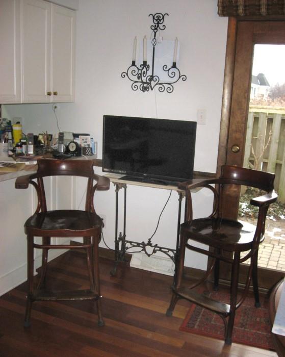 Flatscreen TV, wood bar stools, TV sits on marble top antique table w/wrought iron base