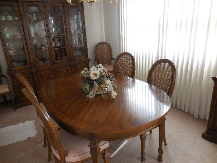 Drexel Heritage Dining Table has 2 leaves.Custom Pads.2 Arm, 4 Side Chairs.Caned Back light Pink Fabric Seats
