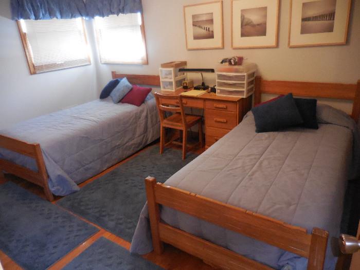 Ranch Oak Twin Head Board/Foot Board Beds Room View has Ranch Oak Desk with Chair.Various Prints on wall.Nice Bed Linen Comforters