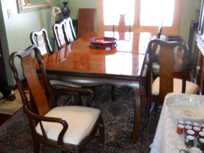 Asian styled dining room has 8 chairs, huge china cabinet, 2 large leaves