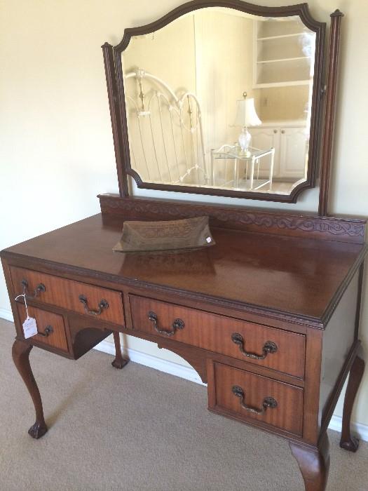  Antique dresser reflecting an iron king headboard & side table.