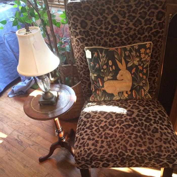 Leopard print chair; 1 of many decorative pillows; small side table & lamp