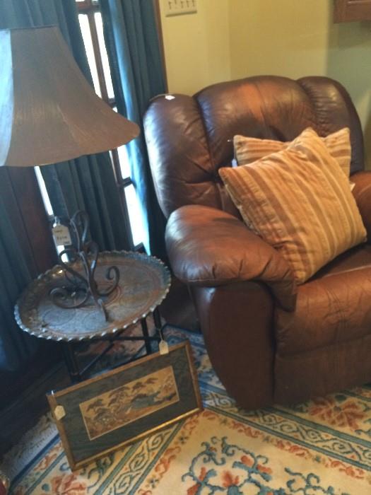 Leather recliner; small side table; 1 of the many lamps