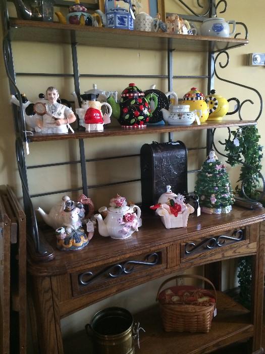               Collection of tea pots; baker's rack