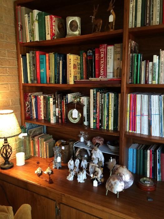 Many books (some very old); Asian mud men; shells