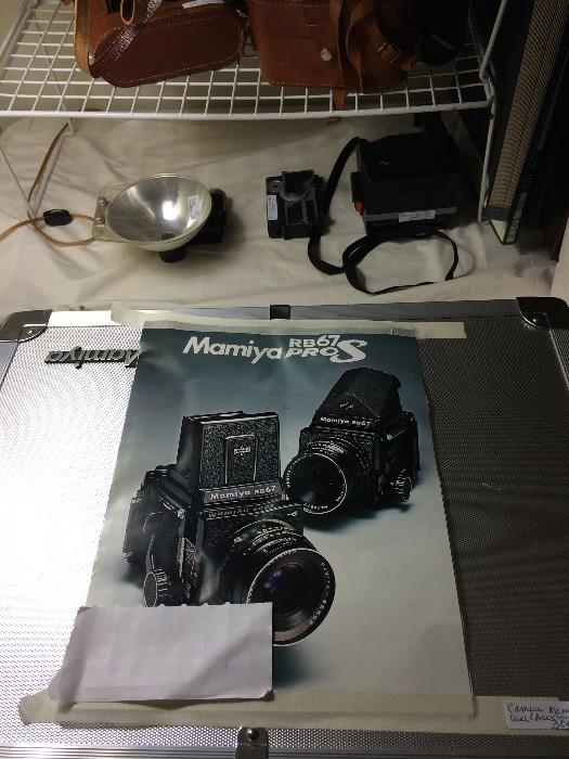 An abundance of cameras, cases, equipment, lens, & accessories