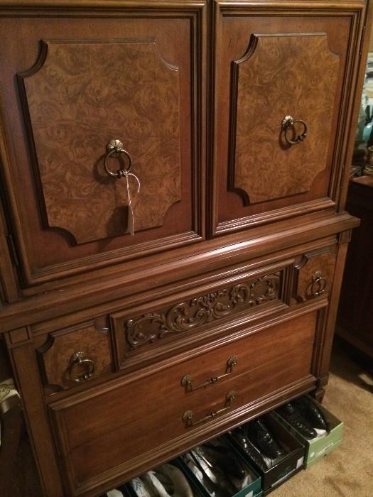 Clothes armoire; some of the many pairs of shoes