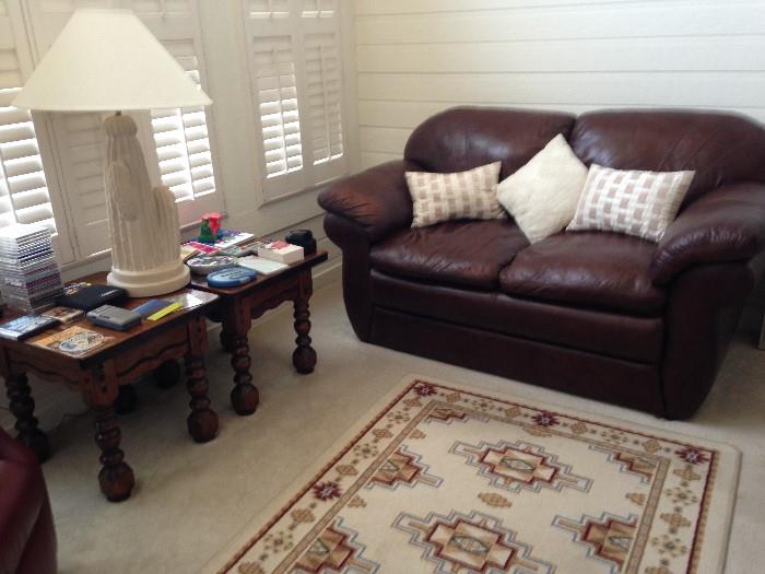 leather couch, end tables, area rug, cd's