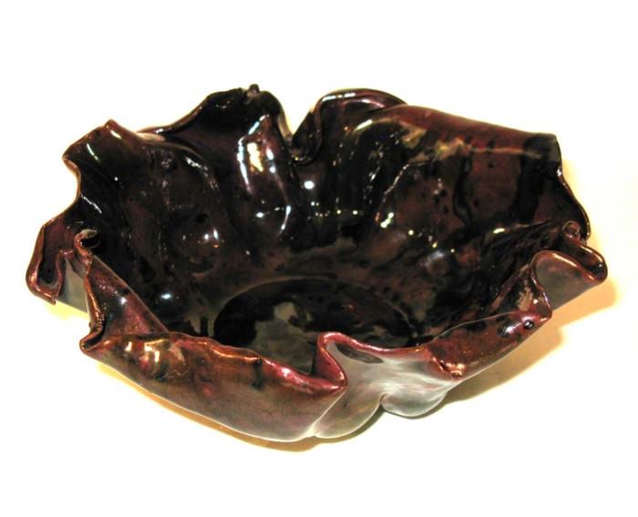 The top of this impossibly thin, unusually glazed George Ohr crimped bowl.