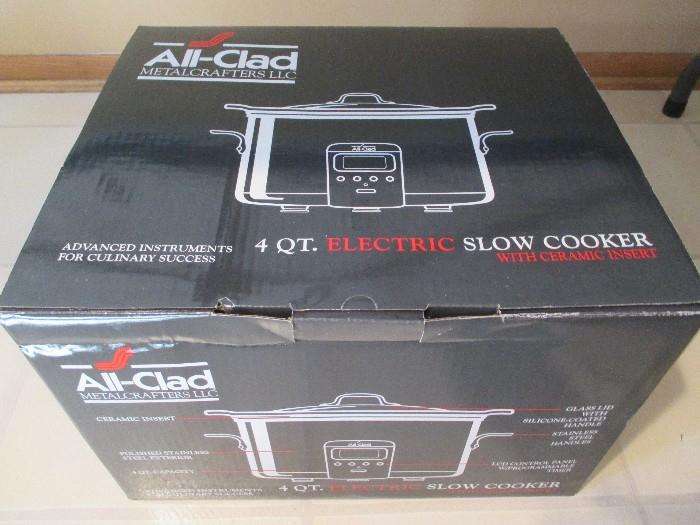 Brand new All-Clad 4qt slow cooker with enamel insert.  Chrome finish