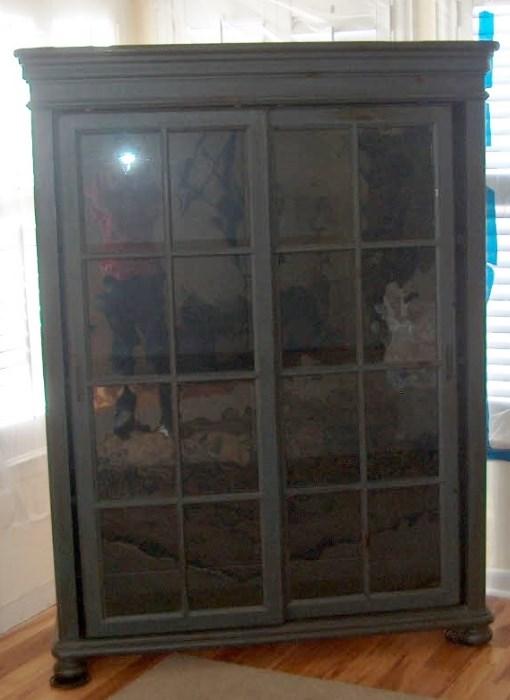 Two Door sliding bookcase with bun feet.