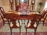 Dining table with 2 leaves and 6 side chairs and 2 arm chairs