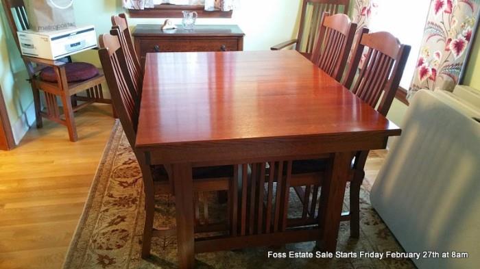 Mission-style dining table and six chairs.
