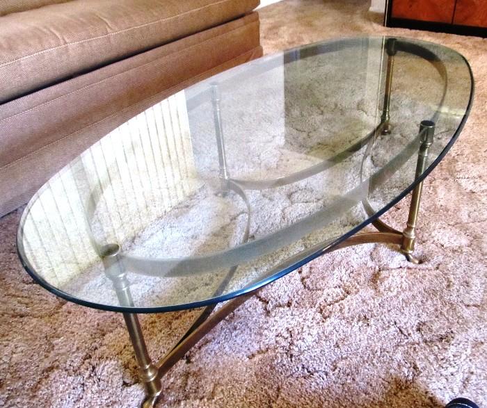 Brass and Beveled Glass Oval Shaped Coffee Table with beautiful footed brass base ,and beveled glass top