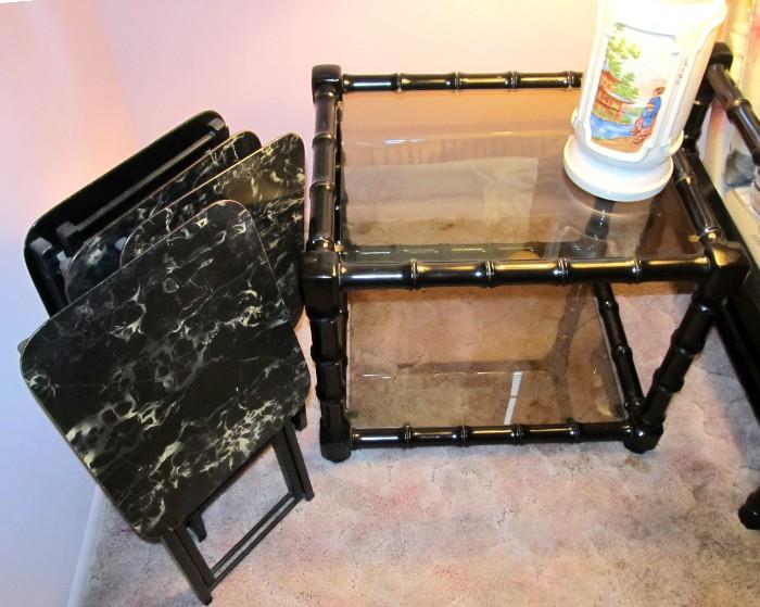 One of two matching Vintage Asian Style End Tables with Black Lacquered Bamboo Style frame and glass insert tops and bottom open style bookshelf storage.  End Tables are part of a Vintage Asian Style Living Room Set that includes Vintage Asian Style sofa...which is shown elsewhere in this collection,   Also shown is an Asian Style Set of 4 TV Trays with Asian Style accents